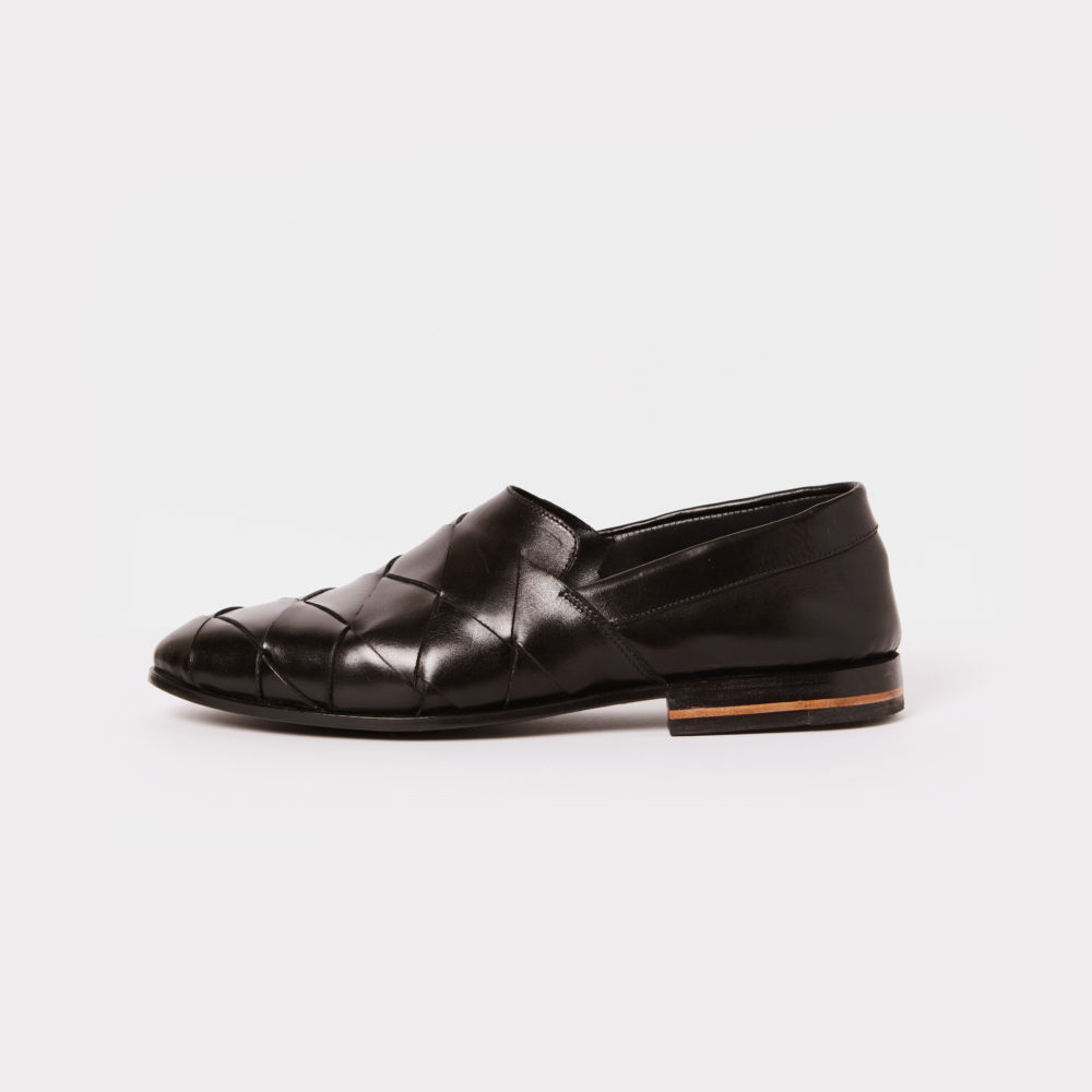 Hand woven slip-on in black leather - left